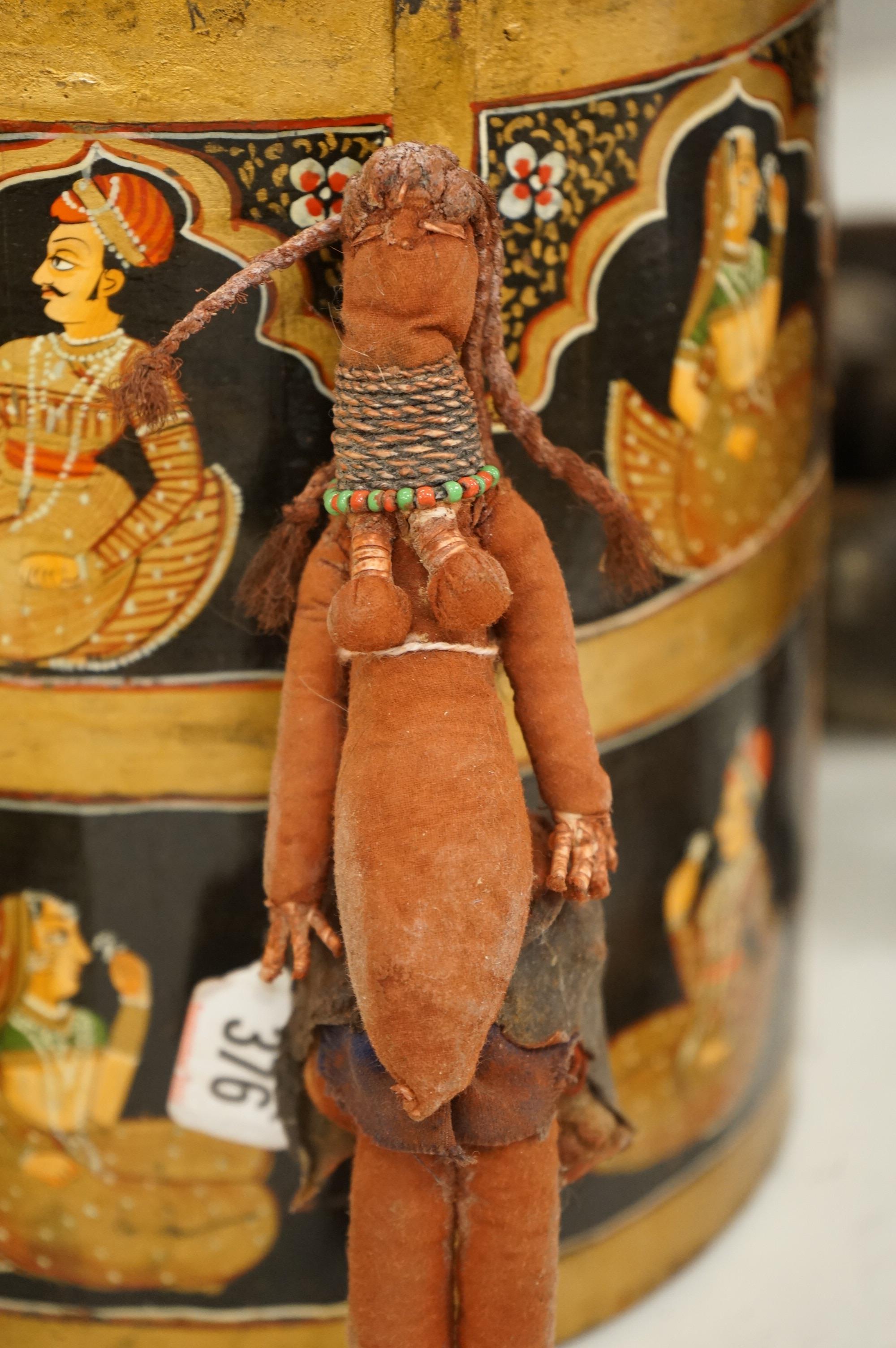 A collection of tribal and Asian collectables including a Tibetan prayer wheel, carvings, etc.